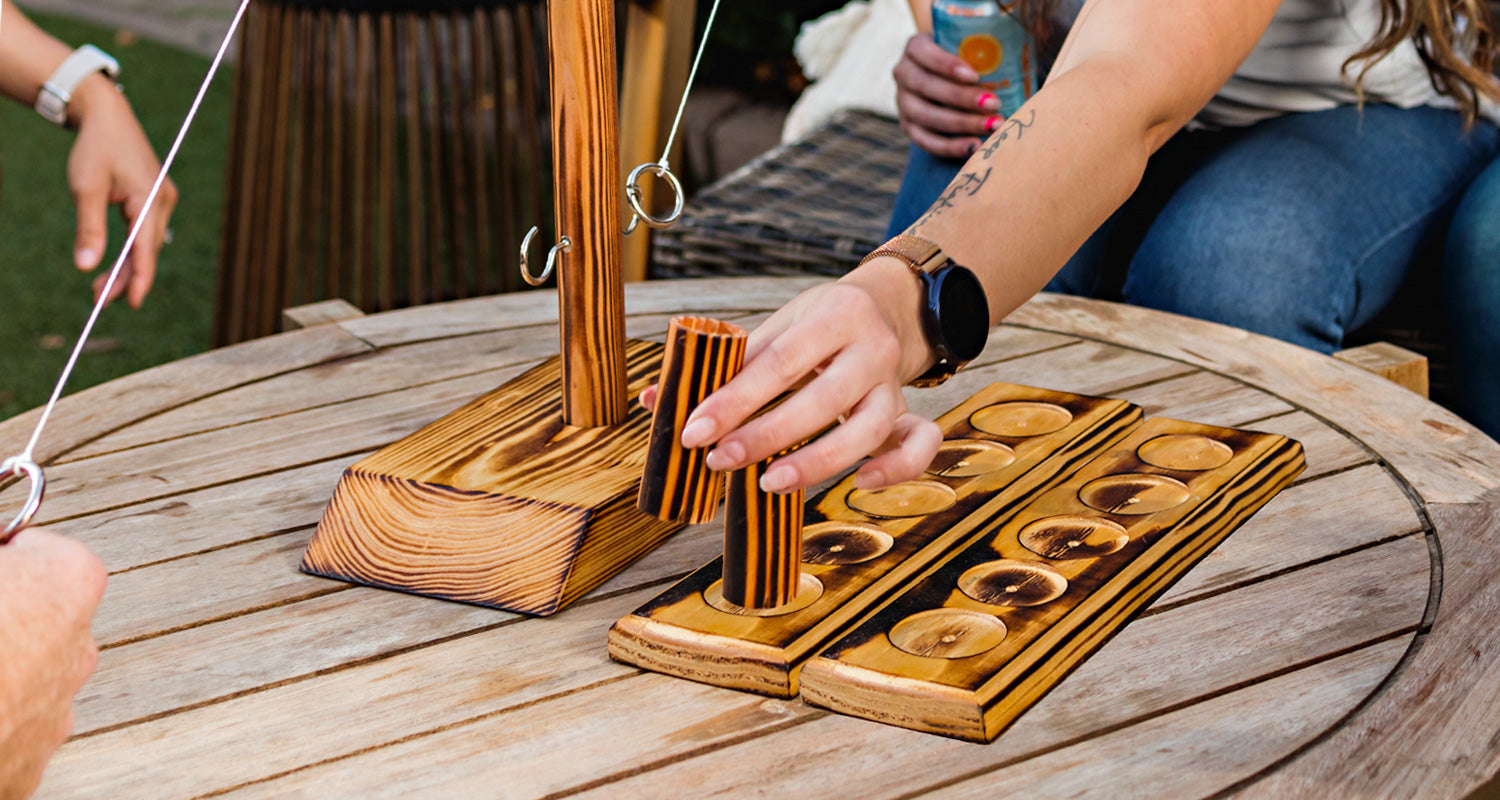 Two opponents playing Chase game mode with tabletop HOOKS! Ring Toss.